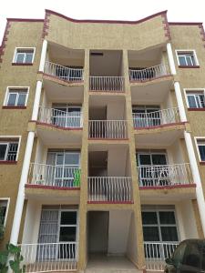 an apartment building with balconies on the side at Lerato's Apartments in Kampala