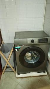 a washing machine with a wheel inside of it at Lerato's Apartments in Kampala