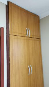 a pair of wooden cabinets in a room at Lerato's Apartments in Kampala
