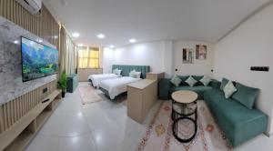 a hotel room with a bed and a couch at Studio Tetouan in Deroua