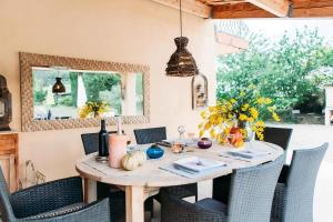 a dining room table with chairs and a table with pumpkins on it at Casa-Manon grande maison de vacances avec piscine in Barjols