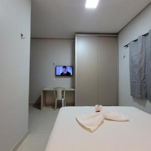 a bedroom with a bed and a tv on a wall at Pousada Loft Marabá in Marabá +55 photos