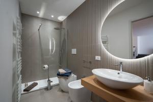 a bathroom with a sink and a toilet and a mirror at Ma Maison 3 in Livorno +17 photos