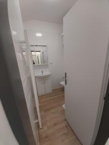 a bathroom with a toilet and a sink and a door at Pleasure 2 Be Here in Dolní Lánov +11 photos