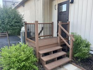 a wooden staircase leading to a house with a door at Apartment in Newark in Newark