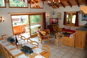a living room with tables and chairs and a couch at Casa-Chalet du Merle N° 2 in Champagny-en-Vanoise