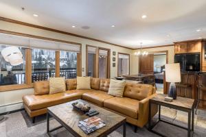 a living room with a couch and a table at Lion Square Lodge South 650 in Vail