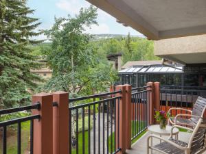 a balcony with chairs and a view of a building at Stonebridge Inn in Snowmass Village +15 photos