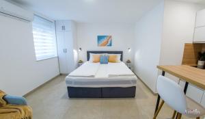 a small bedroom with a bed and a desk at Stari View-Free Parking in Mostar