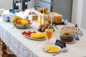 a table with many different types of food on it at Sa Meri B&B in Siamaggiore