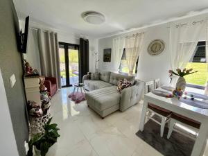 a living room with a couch and a table at Mali Raj in Banja