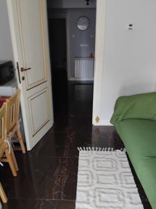 a room with a bed and a clock on the wall at Residence 3 dormitoare in Târgu Neamț