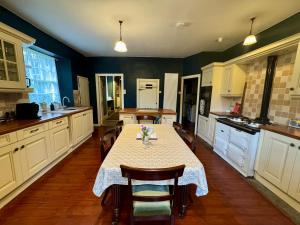 a kitchen with a table and chairs in it at Charming 1700s Country Cottage on a Private Estate in Stirling