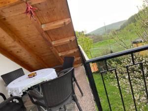 a patio with a table and chairs on a balcony at Riza Guest House in Pukë
