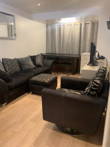 a living room with a couch and a table at Swansea Waterfront in Swansea