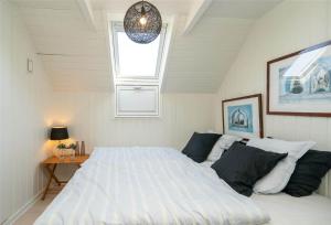 a bedroom with a large bed and a window at 272-Ringkobing-Vestklitvej-22 in Klegod