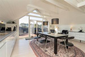 a kitchen with a dining room table and chairs at 272-Ringkobing-Vestklitvej-22 in Klegod