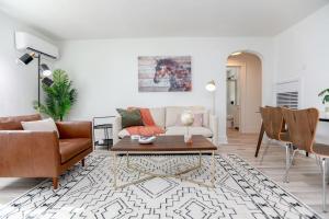 a living room with a couch and a table at Sojourn on the Bay 2 BR Private Beach Access in Norfolk