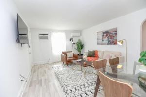 a living room with a couch and a table at Sojourn on the Bay 2 BR Private Beach Access in Norfolk