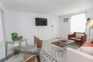 a living room with a couch and a table at Sojourn on the Bay 2 BR Private Beach Access in Norfolk