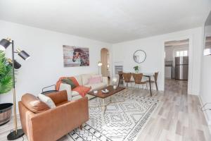 a living room with a couch and a table at Sojourn on the Bay 2 BR Private Beach Access in Norfolk