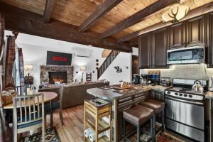 a kitchen with wooden cabinets and a stove top oven at Hideout Pocono Chalet in Lake Ariel