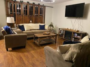 a living room with a couch and a tv at The Farmhouse ranch in Stockton