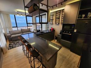 a kitchen and living room with a table and chairs at Mirassol Flats in Natal