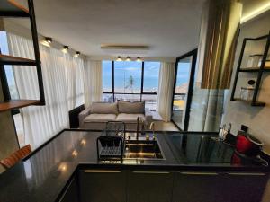 a living room with a couch and a table at Mirassol Flats in Natal +43 photos