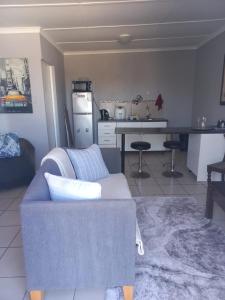 a living room with a couch and a kitchen at 7 Diaz Street Da Nova in Mossel Bay