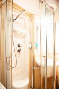a bathroom with a shower and a sink at Lunar artistic loft in Pisa +12 photos