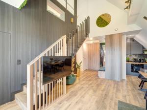 a living room with a staircase and a dining room at Apartament Panorama Lake & Ski in Kluszkowce +35 photos