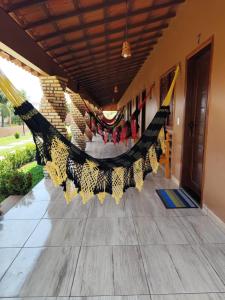 a room with a hammock on the floor at Pousada Brisa das Dunas in Paulino Neves