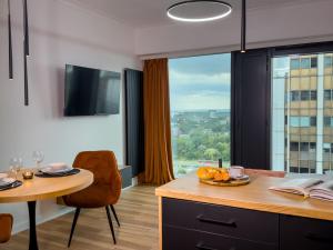 a kitchen with a table and a large window at URBAN APARTMENTS GLOBAL SkyLine 23rd floor No 8, Garage, Self Check-in, No Deposit in Katowice