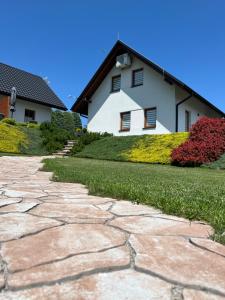a stone walkway in front of a house at Apartamenty Jaworzynka in Jaworzynka