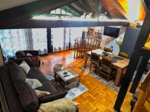 a living room with a couch and a table at Šumska Bajka in Orahovica