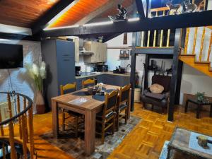 a kitchen and dining room with a table and chairs at Šumska Bajka in Orahovica