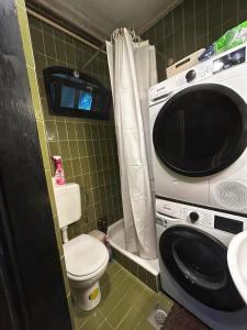 a small bathroom with a toilet and a microwave at Šumska Bajka in Orahovica