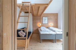 a bunk bed room with two beds and a ladder at 711-Hvide-Sande-Slusen-11 in Hvide Sande
