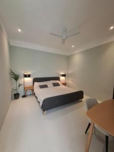 a bedroom with a large bed and a table at Casa Maria in Żabbar