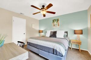 a bedroom with a bed and a ceiling fan at Modern Getaway North of Panama City Beach in Panama City
