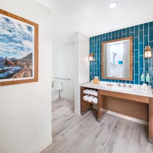 a bathroom with a sink and a mirror at Compass by Margaritaville Flagler Beach in Flagler Beach