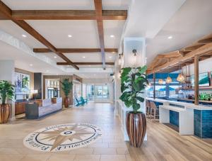 a lobby with a bar and a plant at Compass by Margaritaville Flagler Beach in Flagler Beach