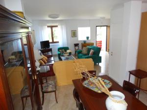 a living room with a couch and a table at Silenzi Holiday Home in Fertilia