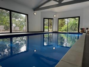 a swimming pool in a house with windows at A Casa Catalina - Charming villa in Afa