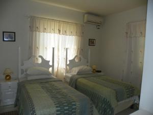 Ένα ή περισσότερα κρεβάτια σε δωμάτιο στο AnnJenn Apartments