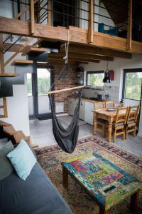 a hammock hanging from the ceiling of a room at WIATR W KOMINIE dostęp do jeziora UBLIK in Konopki Wielkie