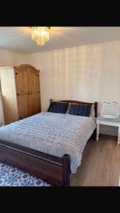a bedroom with a bed and a chandelier at Swansea Waterfront in Swansea