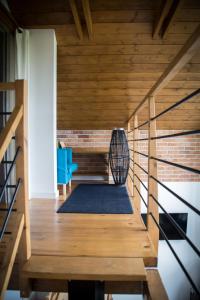 a room with wooden flooring and a staircase with a chair at WIATR W KOMINIE dostęp do jeziora UBLIK in Konopki Wielkie