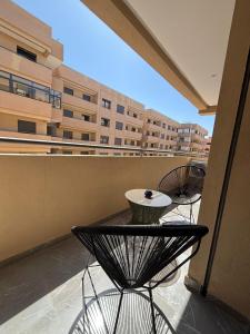a balcony with a table and chairs on a building at Nice apartment in Marrakesh in Marrakesh